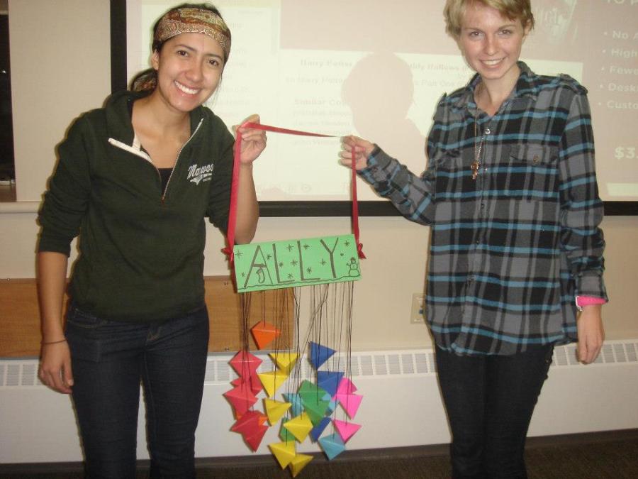 Laura Avella (left) and Lydia Fulton (right) post with an ornament