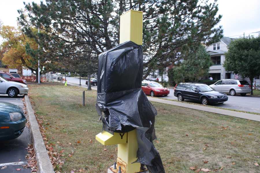 A campus safety call box wrapped in plastic is unusable in the Nazareth Hall parking lot.