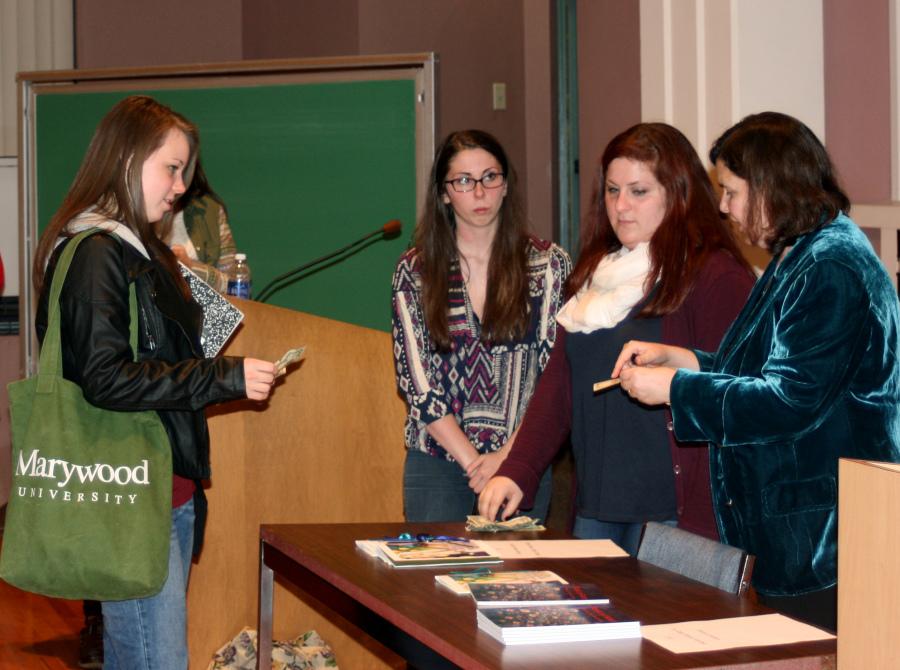 Sally Rosen Kindred signs her book for Marywood student,  Brynna Tebbe, following her poetry reading at the Comerford Theatre in the Center for Natural and Health Sciences.