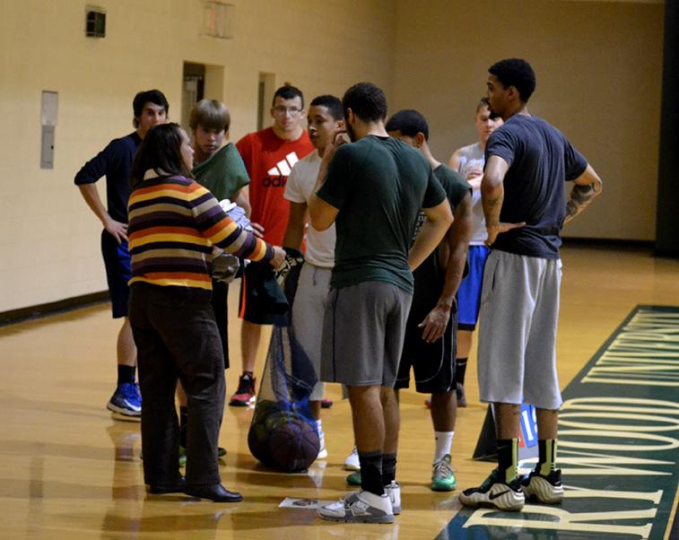 The commuter basketball team is entering their inaugural season. The team
gathers around to discuss upcoming practice schedule.  