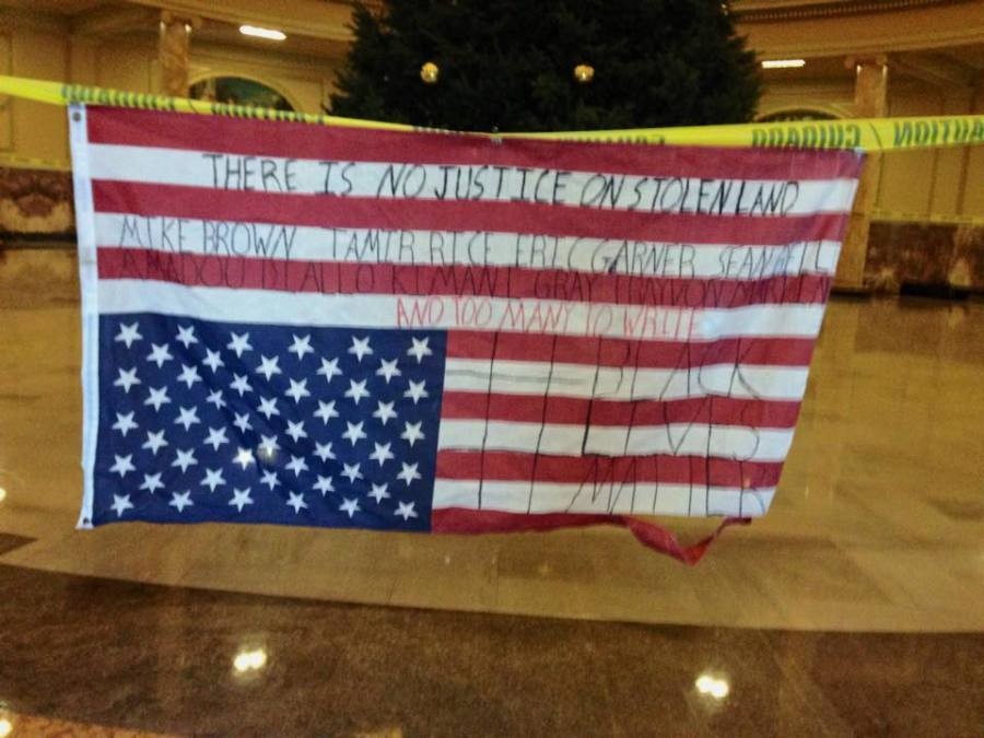 The+U.S.+Flag+hangs+upside+down+and+written+upon+in+the+photo+that+sparked+the+controversy.