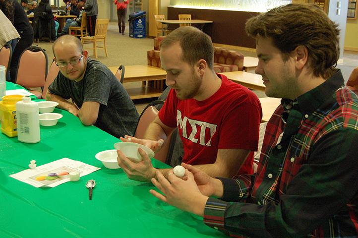 Junior architecture majors Andrew Reynolds, Tom Ellis, and Chard Howley learn how to make a bouncy ball at the SAC DIY event.