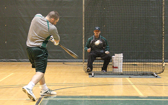 Due to the inclement weather the baseball team has had to practice in the gym. The practices consist of batting drills and fielding drills.