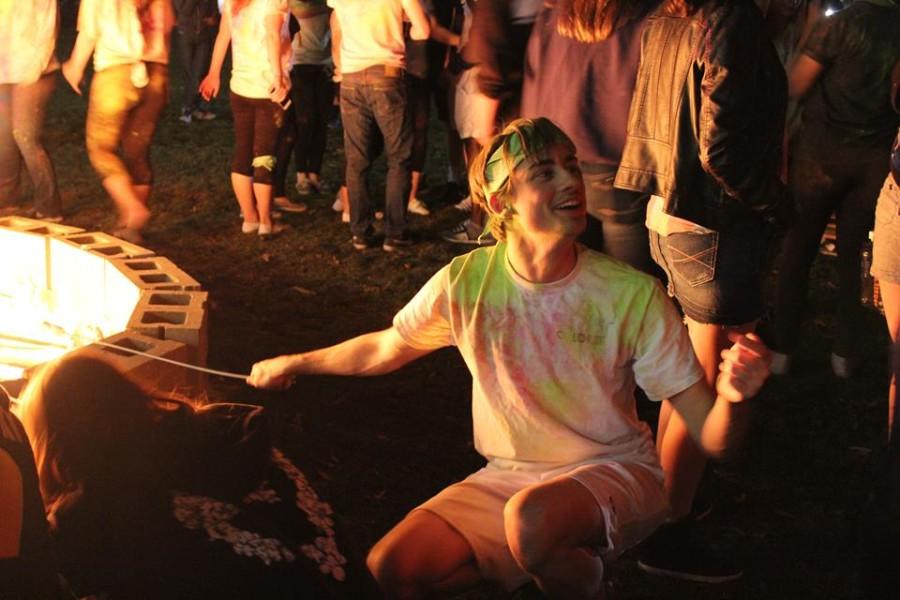 After participating in the Color Fest, SAC member, Tom Muscarello, makes s'mores.