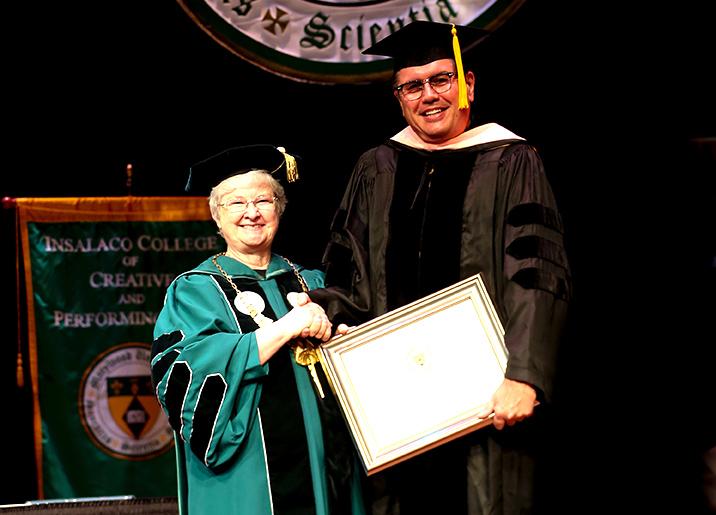 Sr.+Anne+poses+with+Dr.+F.+David+Romines+as+he+receives+his+faculty+award+at+the+2014+Convocation.+