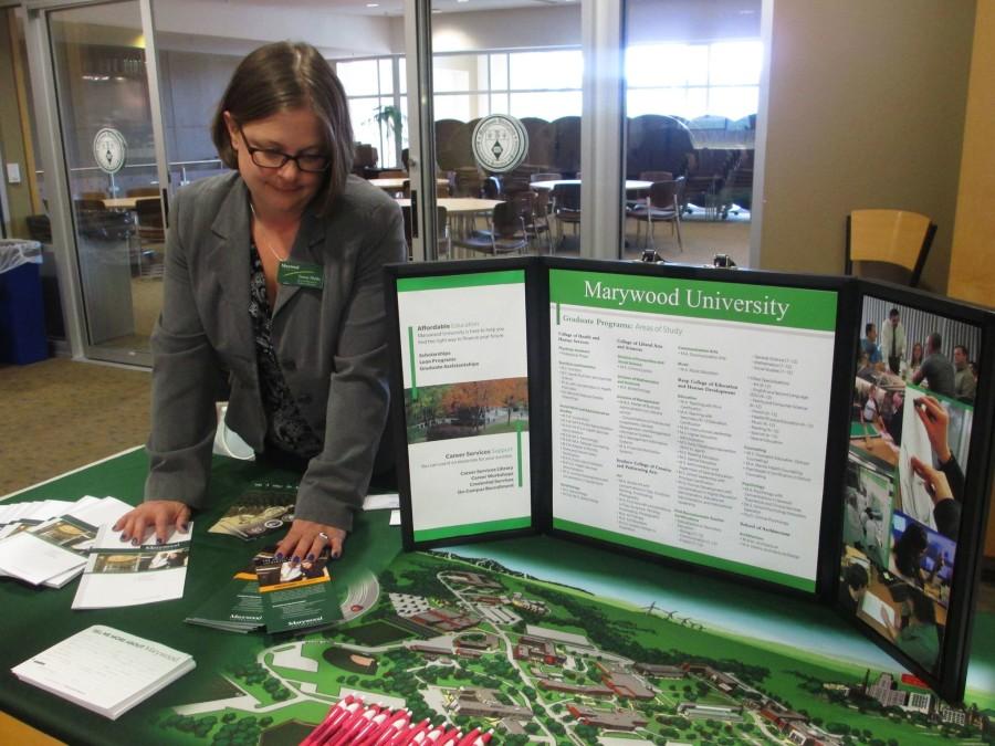 Tammy Manka, Associate Director for Graduate Recruitment, stands by the Marywood table at the first Graduate School Fair in the Fireplace Lounge. 