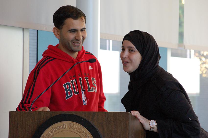 Refugee Mohammad Feras Almahameed shares his story (with Hasnae Abouhilal translating) at the Refugee Day event in the Learning Commons. 