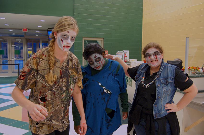 Students Janet Herington, Nadine Burton, and Amanda Marchese pose in their zombie makeup before SACs Zombies vs. Humans event. 