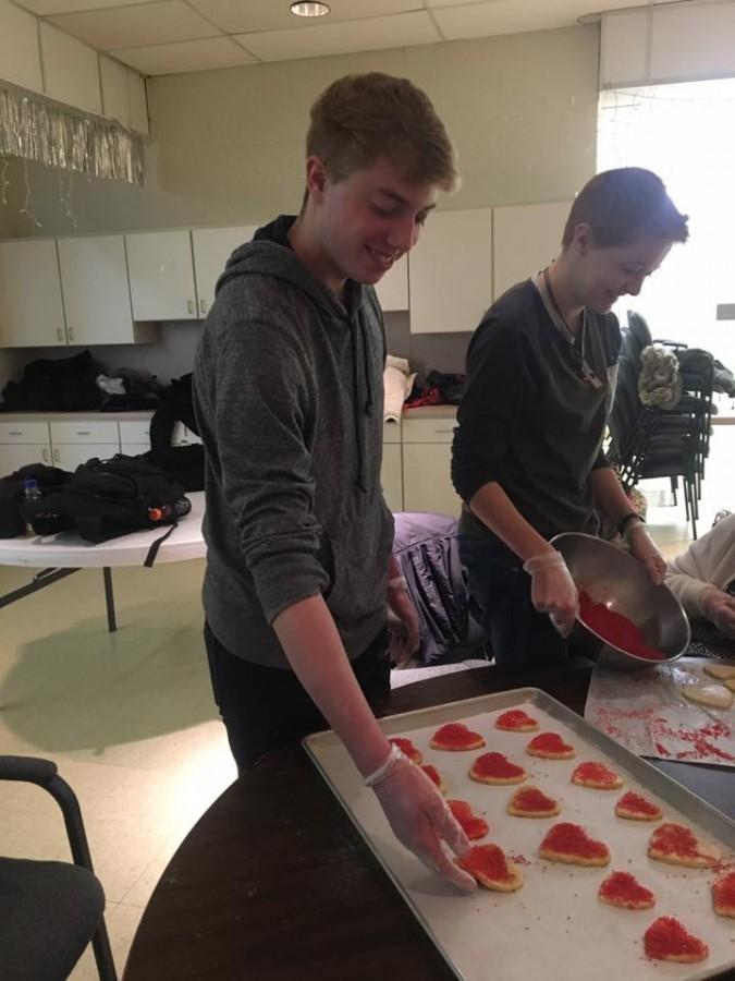 Ryan Calamia, freshman early childhood education major, and Emily Schweiger, senior psychology major, help bake cookies with the senior citizens. 