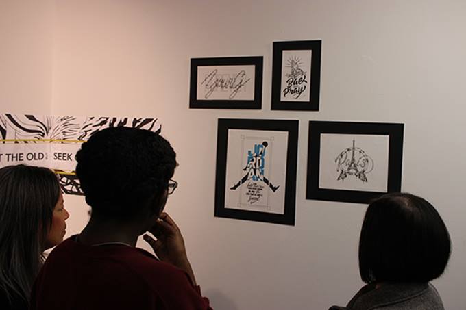 Students look at the work on display at the Genesis: Art Through The Ages exhibit.