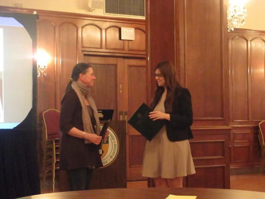 Dr. Samantha Christiansen awards Eva Polizzi, the graduate winner of the Women's Studies Writing Contest.