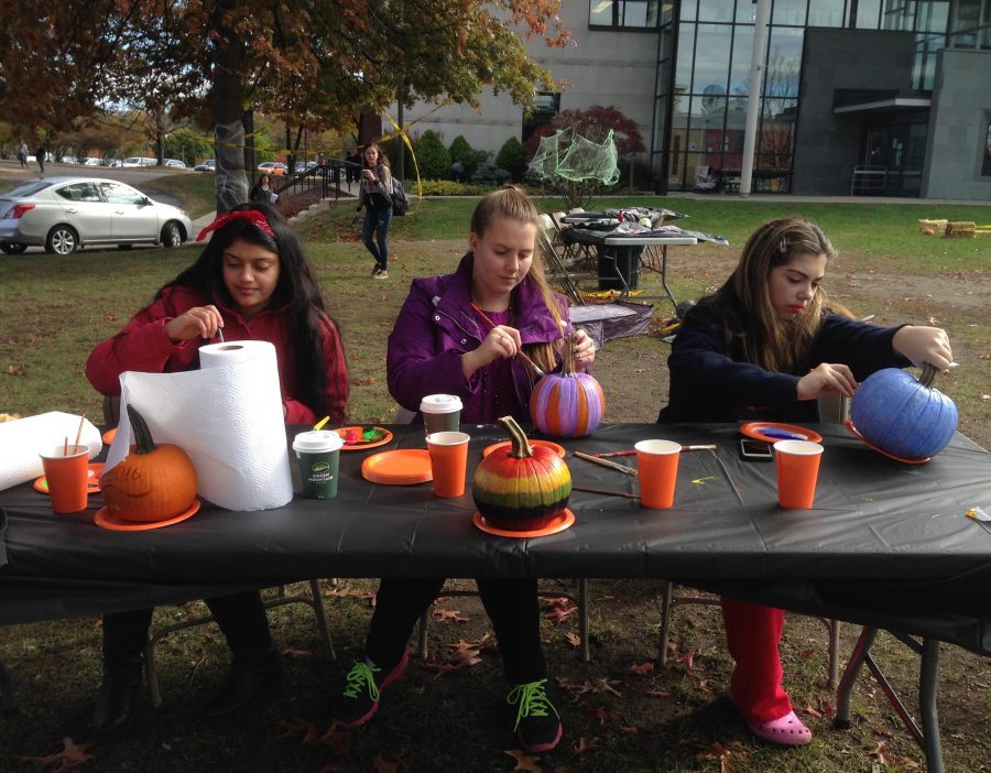 Salma Ahmed, Becca Lukasak and Haley Salvo paint pumpkins at the SAC-tacular Spookfest. 