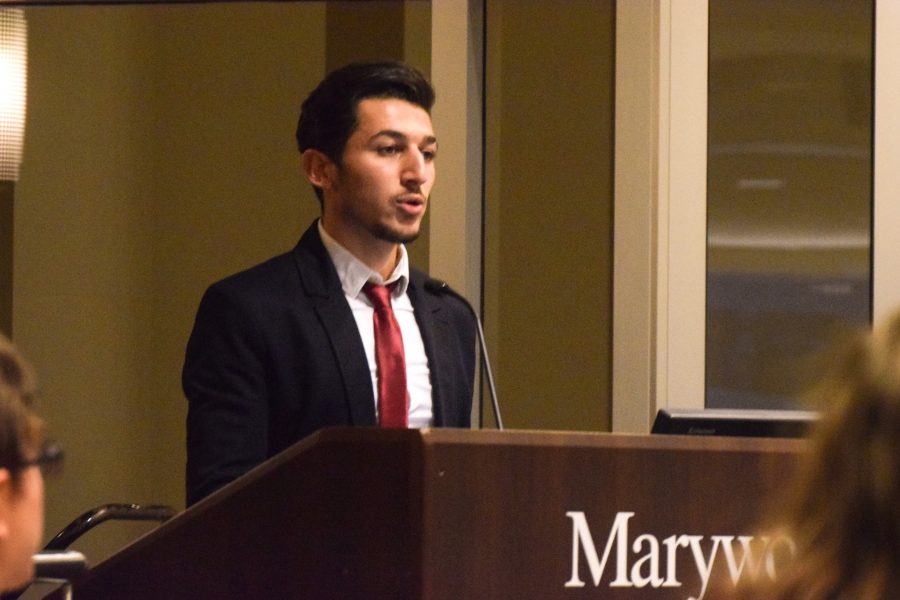 Anas Allouz speaks about his experiences in Syria to a crowd in the Upper Main Dining Hall.