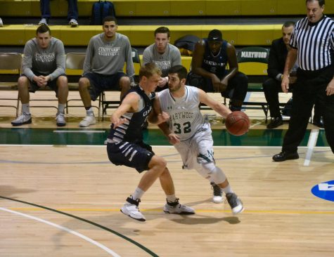 Marywood junior guard James Curley drives on a Centenary defender in a 63-77 home opener loss.