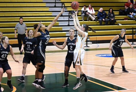 Photo courtesy of Marywood Athletics. Caption: Junior guard Catie Nealon attempts a jump shot over Lebanon Valleys Jasmine Copeland.