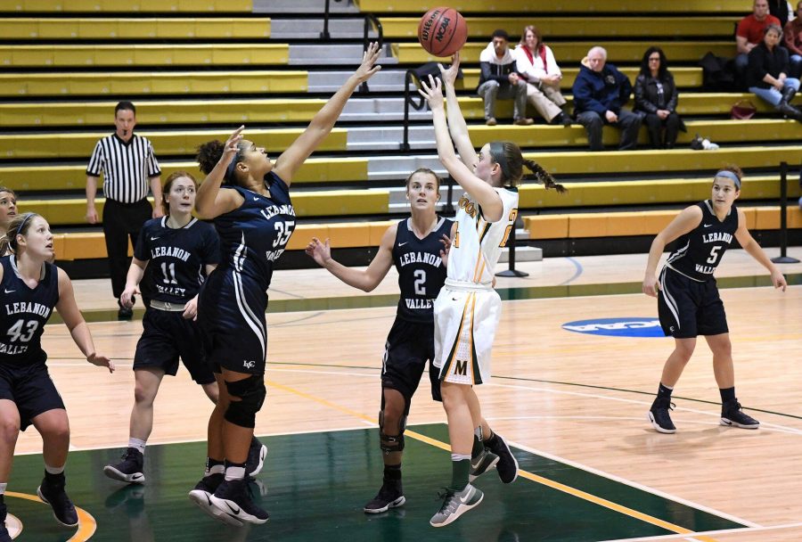 Photo courtesy of Marywood Athletics. Caption: Junior guard Catie Nealon attempts a jump shot over Lebanon Valley's Jasmine Copeland.