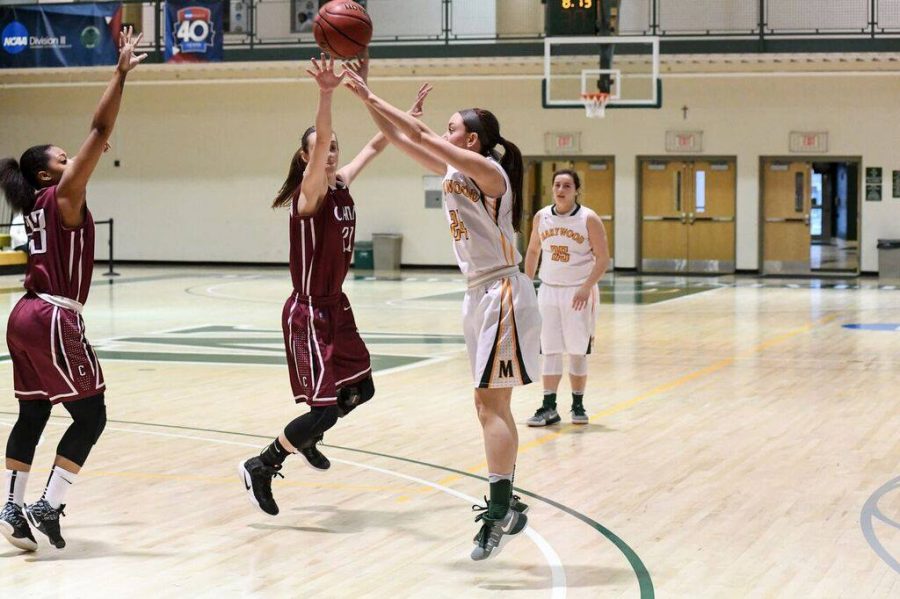 Junior guard Catie Nealon shoots jump shot over a Carin defender in blowout victory. Photo courtesy of Marywood Athletics.