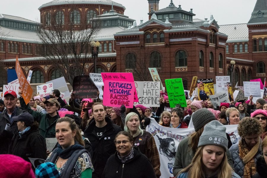 Participants walk past the Smithsonian Castle during the march.