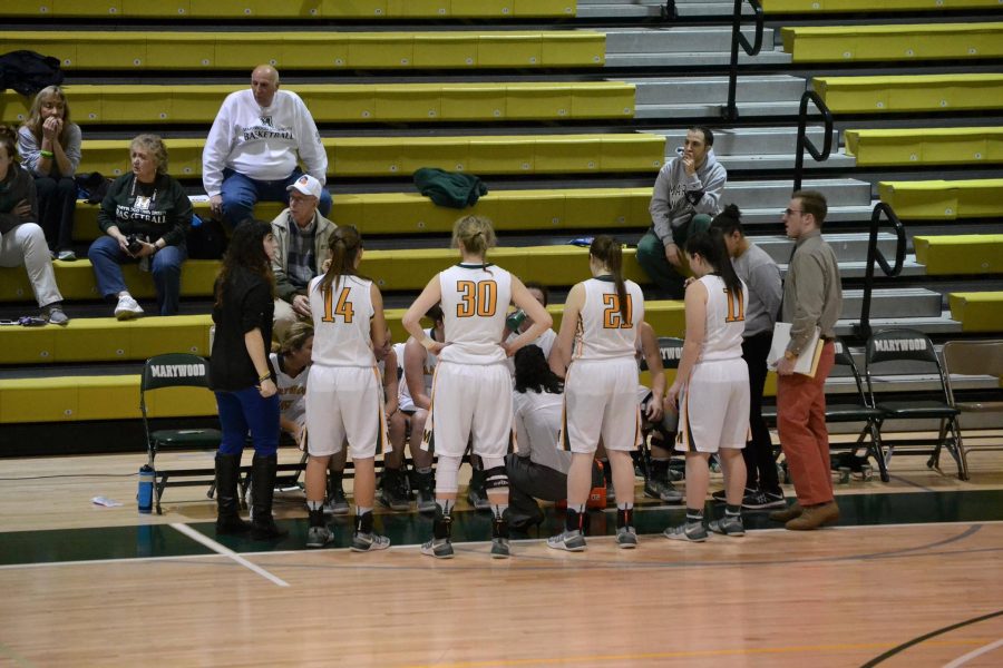 Womens basketball head coach Tara Macciocco talks to her team during a timeout.