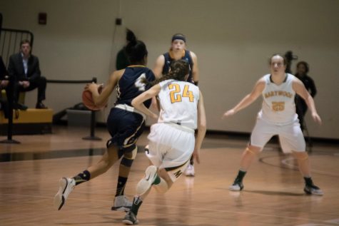 Marywood Junior Captain Catie Nealom rushes in to defend Neumanns Shauntel Williams.