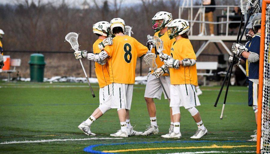 Members of the Marywood mens lacrosse team celebrate a goal against Wilkes University. Photo courtesy of Marywood Athletics. 