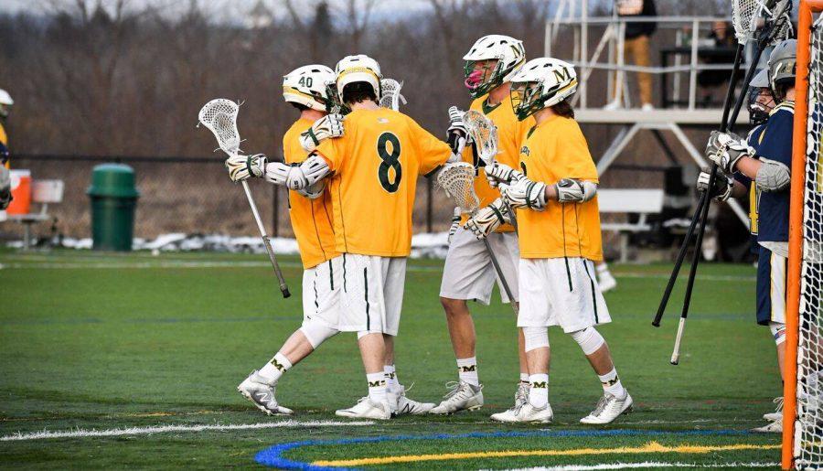 Members of the Marywood men's lacrosse team celebrate a goal against Wilkes University. Photo courtesy of Marywood Athletics. 