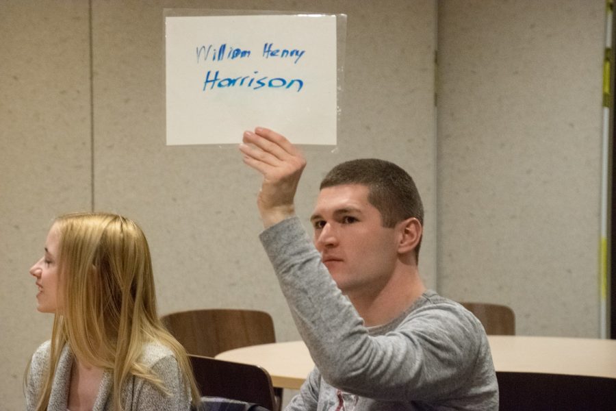 Tom Skrutski, a junior business management major, answers a question on behalf of his team.