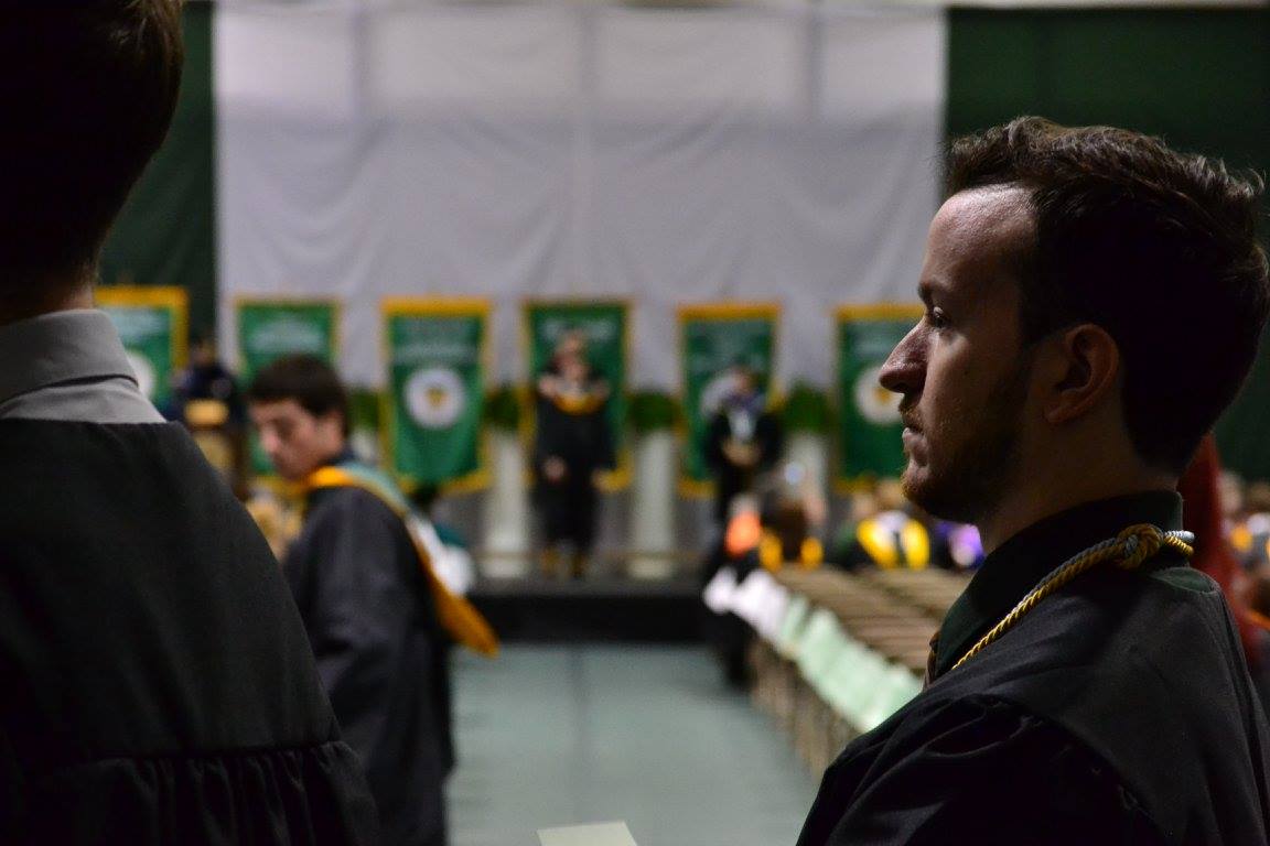 Travis Murray, a marketing major, stands in line to be hooded.