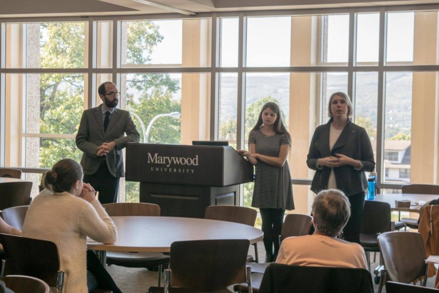 Dr. Adam Shprintzen, assistant professor of history, Brooke Williams, SCJ President and a junior broadcast journalism major, and Dr. Lindsey Wotanis, associate professor and director of Broadcast Journalism address the crowd.