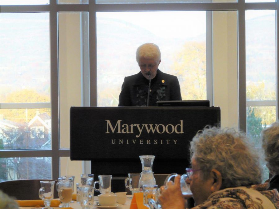 Sr. Catherine Luxner welcomes guests with a speech about services and the Thanksgiving Adopt-a-Family drive.