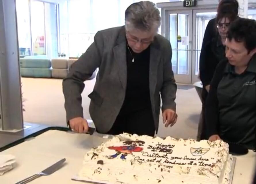 President Sr. Mary Persico cuts her birthday cake.