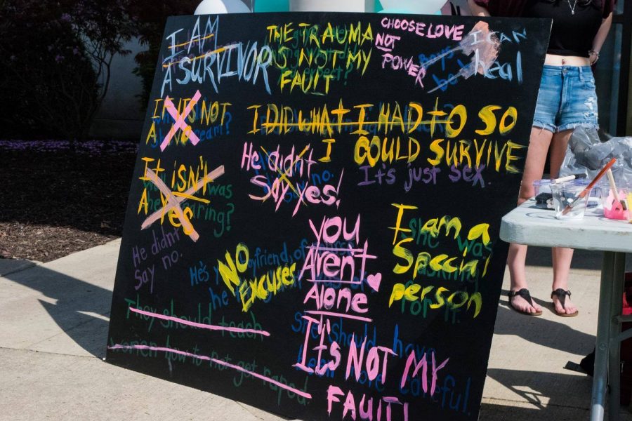 Photo from 2017 Release the Light Event. Students painted over common excuses for sexual assault with more positive affirmations.