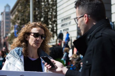 Sports Editor John Ferraro asks Karen Siatras from Maine questions about why she marched in Washington D.C. Photo credit: Manfid Duran