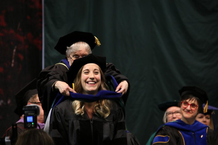 A student receives her hood.