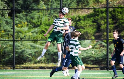 Zac Lloyd gets up high to head a ball. Photo courtesy of Marywood Athletics