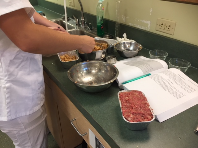 A nutrition and dietetics student works on a recipe in a food lab. Photo courtesy of Dr. Diane DellaValle