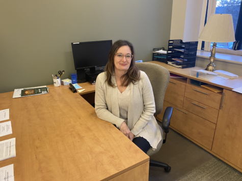 Amy Fotta sits at her desk in the Swartz Center for Spiritual Life. Fotta returned to campus in October as the new director of community service and social justice.
