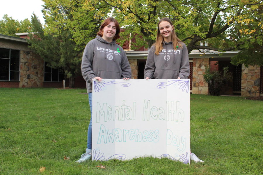 Student organizers, Katie Csisack (left) and Alyssa Tkacz (right) hold "Mental Health Awareness Day" sign.