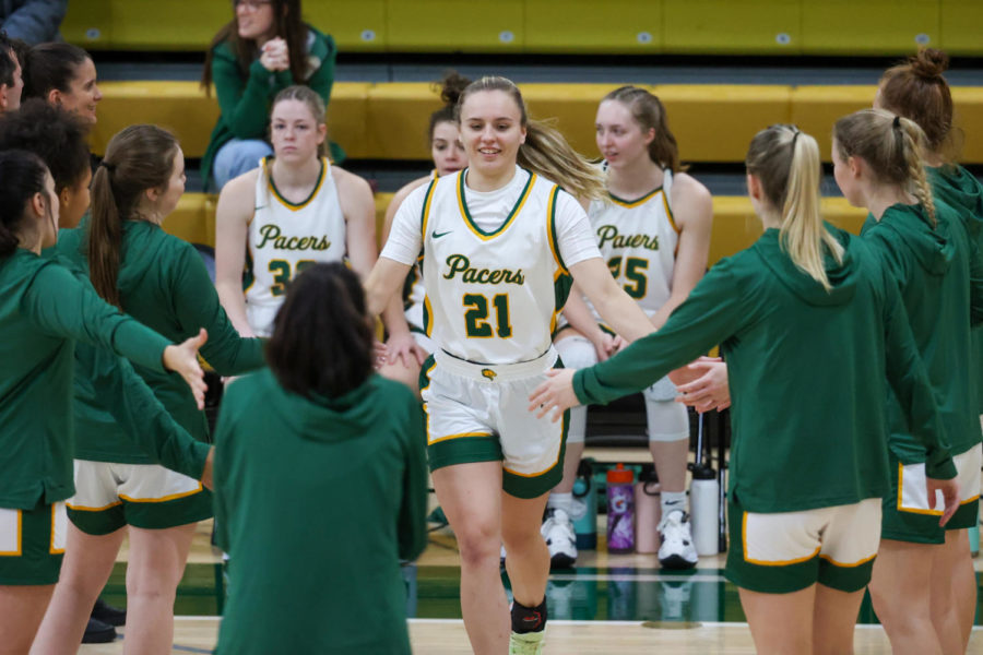 Abbey McGee (21) is greeted by her teammates