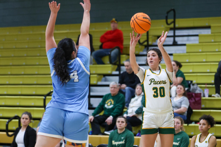 Freshman Forward Maddie Neiderer (30)  shoots the corner three.