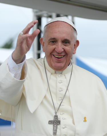 Pope Francis smiles and waves