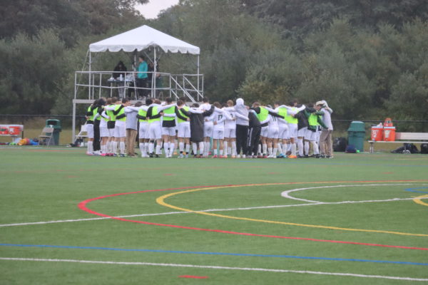 The Pacers in a huddle before facing Arcadia University.